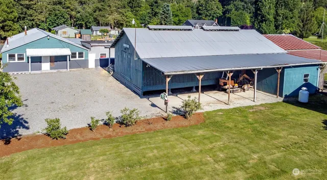 an aerial view of a house with swimming pool and patio