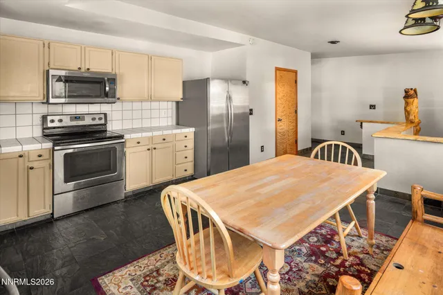 a kitchen with kitchen island a stove a sink and a refrigerator