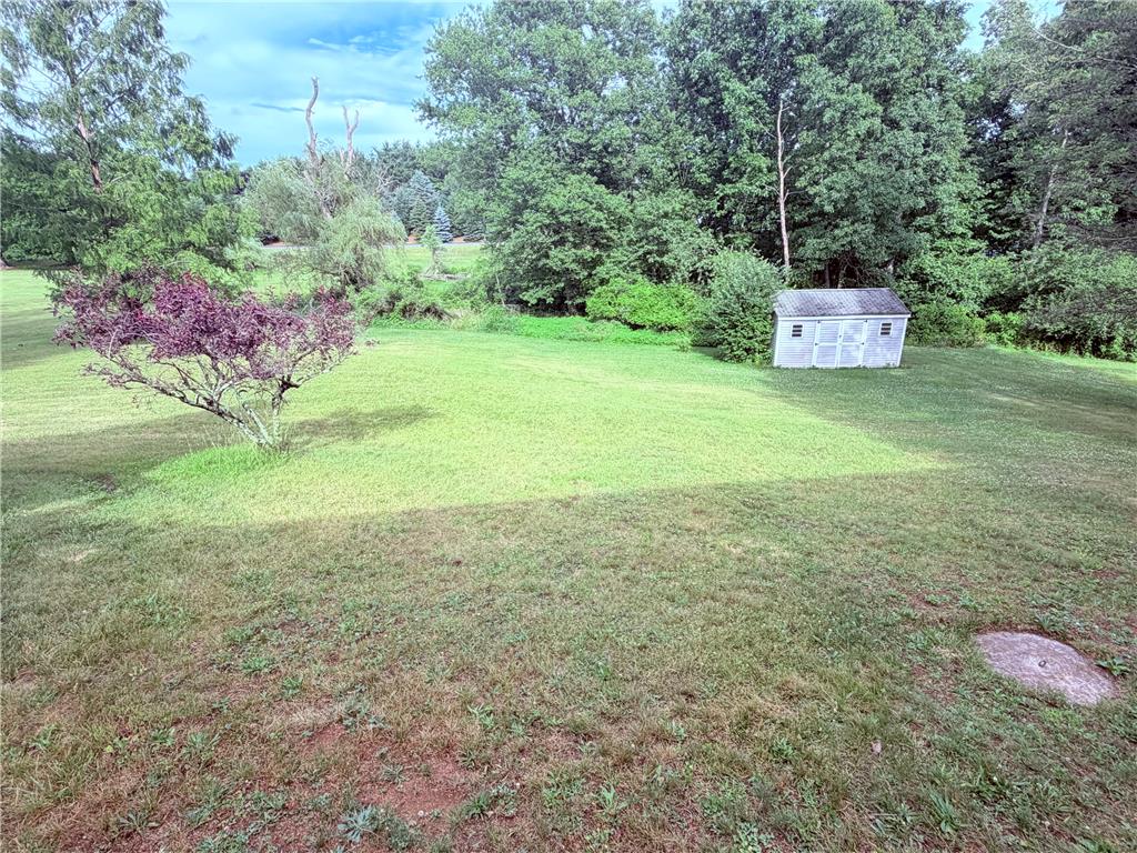 5963 Valley Road Slatington, PA 18080 - Photo 18 of 20 A verdant backyard with mature trees and a charming storage shed.