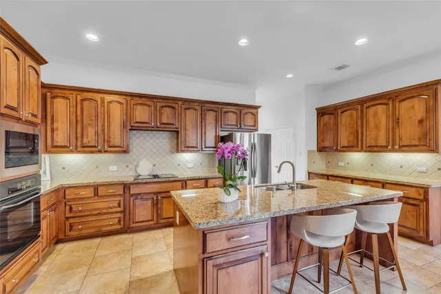 a kitchen with granite countertop a sink and cabinets