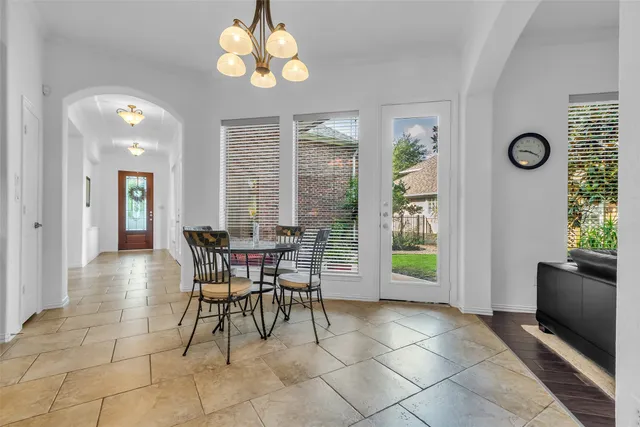 a view of a dining room with furniture and chandelier