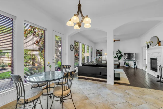 a view of a livingroom with furniture wooden floor and a large window