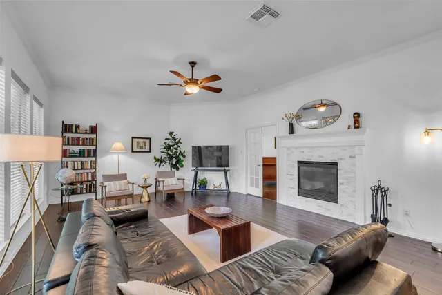 a living room with furniture a fireplace and a flat screen tv
