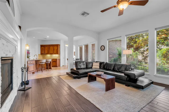 a living room with furniture and a wooden floor