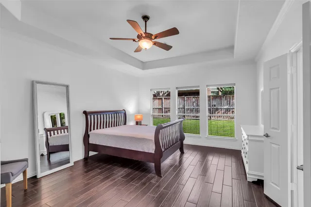 a living room with a bed furniture and a large window
