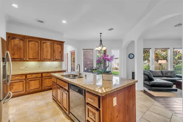 a kitchen with stainless steel appliances granite countertop a sink and cabinets