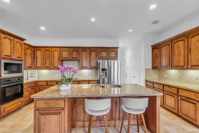 a kitchen with granite countertop a sink and cabinets
