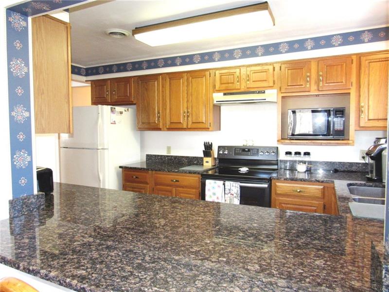 354 Lake Road Somerset, PA 15502 - Photo 2 of 25 The extended granite counter top reaches into the dining room. There's plenty of cupboard and drawer space!