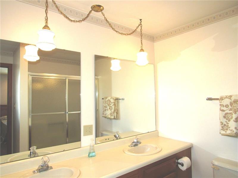 354 Lake Road Somerset, PA 15502 - Photo 12 of 25 Double sinks allow for more than one at time to be washing up! You can see the tub/shower in the mirror. Let's check out the master bedroom!