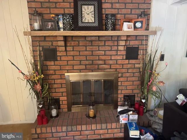 a living room with furniture a lamp and a fireplace
