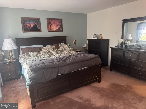 a bedroom with a bed and windows