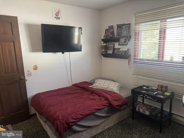 a bedroom with a bed and a mirror