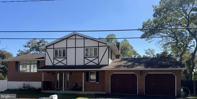 a view of house with roof deck and seating space