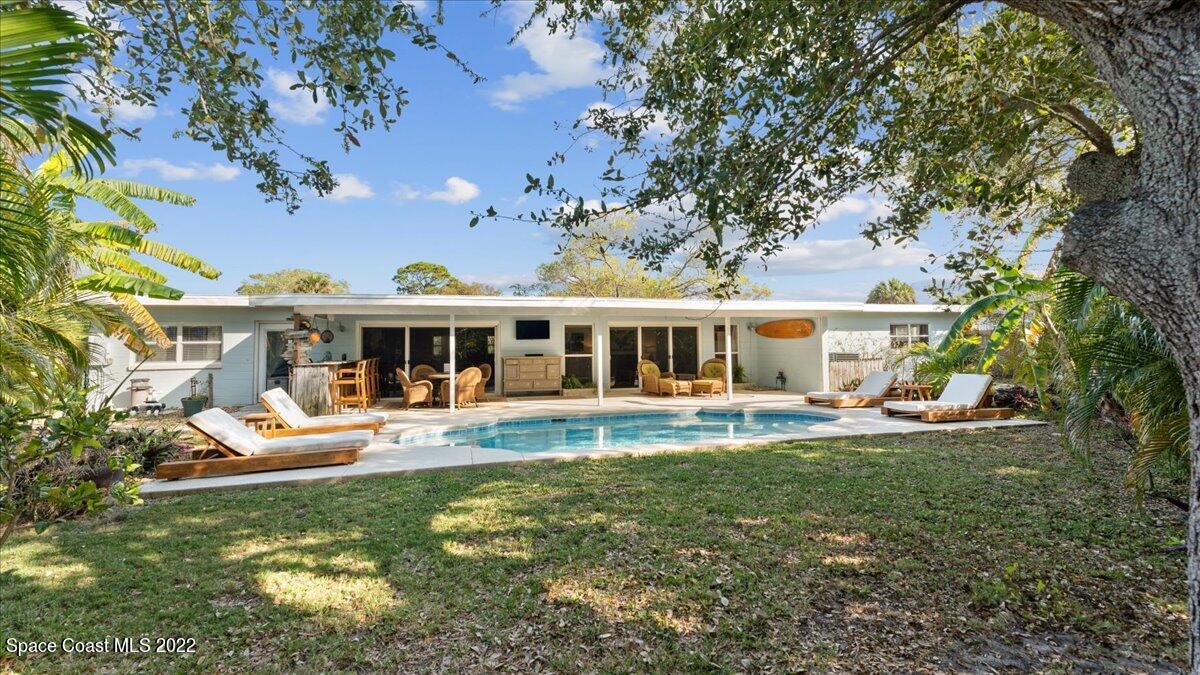 912 Bali Road Cocoa Beach, FL 32931 - Photo 1 of 48 front view of a house with a big yard