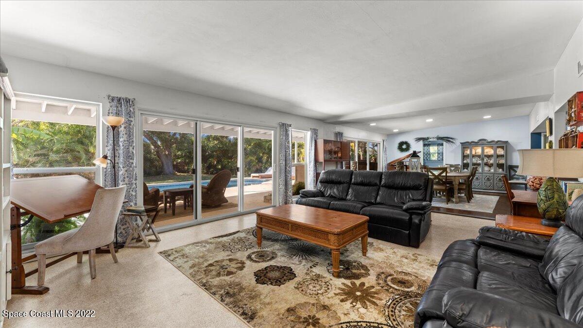 912 Bali Road Cocoa Beach, FL 32931 - Photo 13 of 48 a living room with furniture and a fireplace