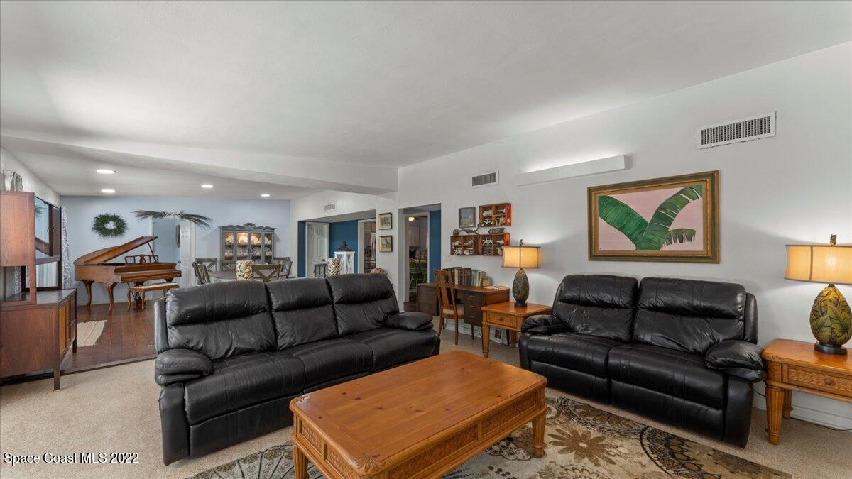 912 Bali Road Cocoa Beach, FL 32931 - Photo 14 of 48 a living room with furniture and a couch