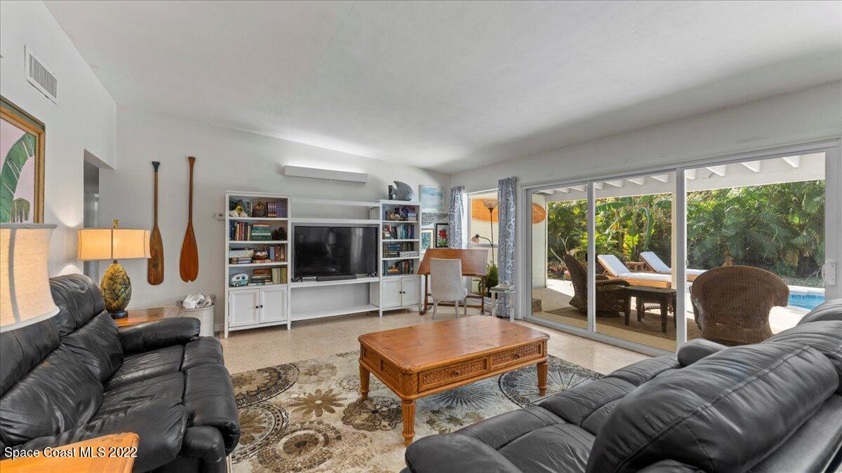 912 Bali Road Cocoa Beach, FL 32931 - Photo 15 of 48 a living room with furniture and a flat screen tv