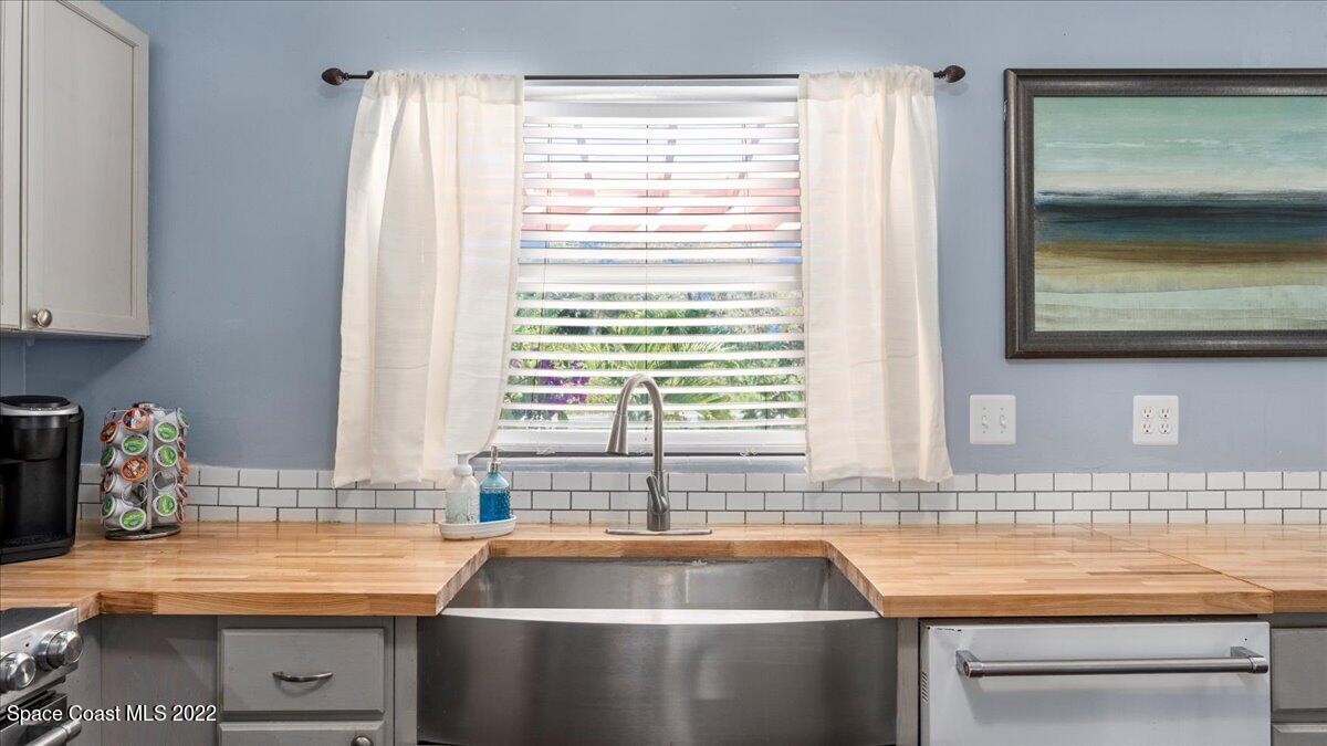 912 Bali Road Cocoa Beach, FL 32931 - Photo 17 of 48 a kitchen with stainless steel appliances a sink and a window