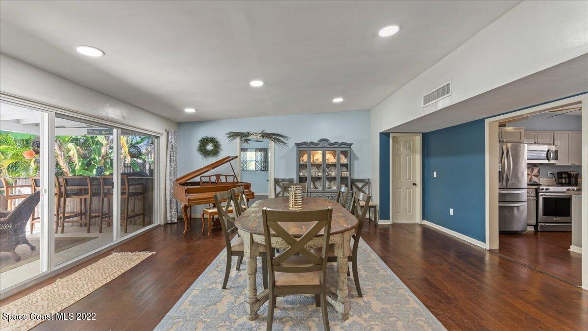 912 Bali Road Cocoa Beach, FL 32931 - Photo 18 of 48 a dining room with furniture and wooden floor