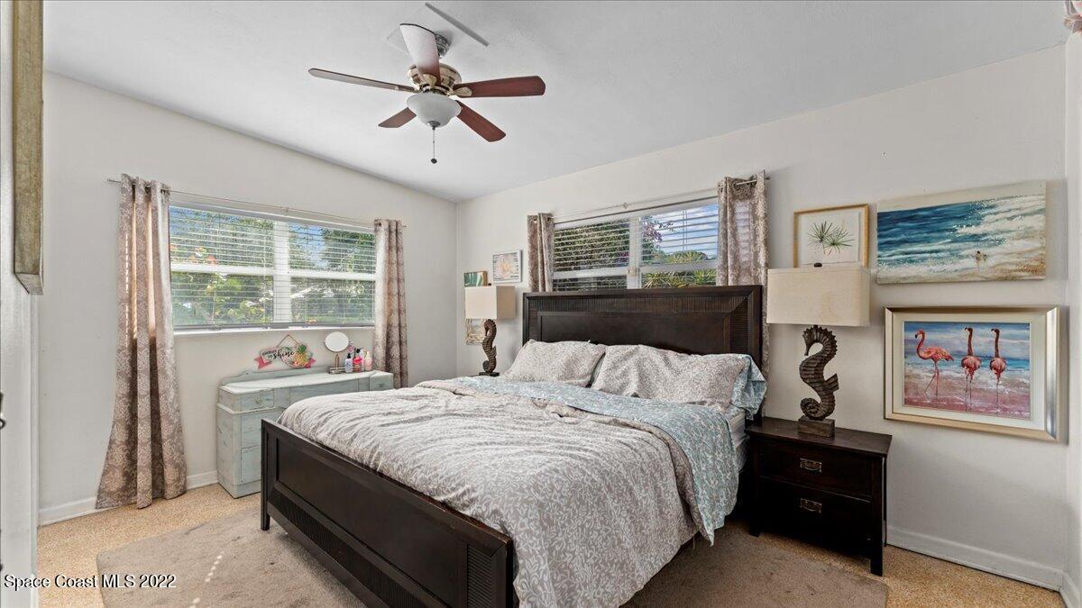 912 Bali Road Cocoa Beach, FL 32931 - Photo 19 of 48 a bedroom with a bed and a window
