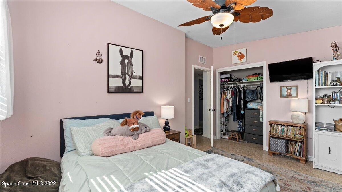 912 Bali Road Cocoa Beach, FL 32931 - Photo 24 of 48 a bedroom with a bed and flat screen tv