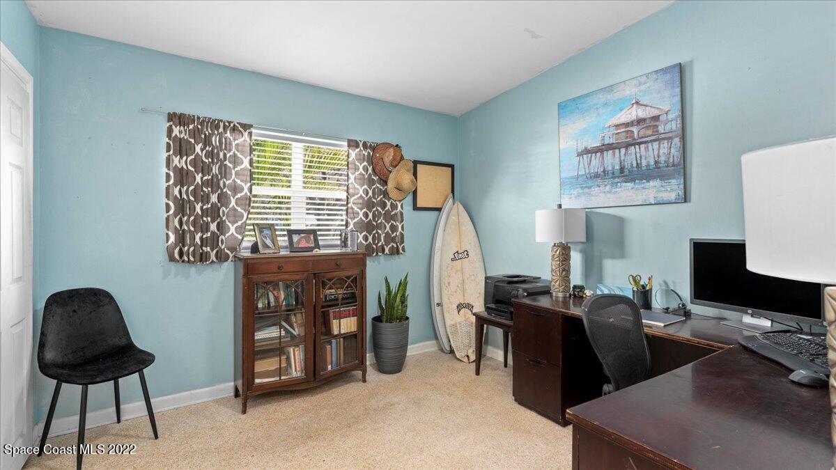 912 Bali Road Cocoa Beach, FL 32931 - Photo 26 of 48 a view of a workspace with furniture and a window