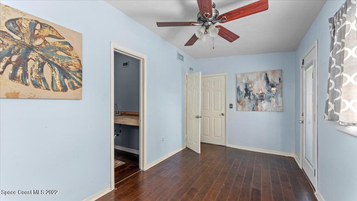 912 Bali Road Cocoa Beach, FL 32931 - Photo 30 of 48 a view of an empty room with window and wooden floor