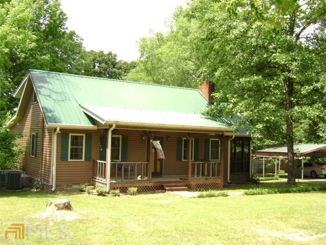 1151 Radio Springs Road Southwest Rome, GA 30165 - Photo 1 of 1 a view of a house with a large tree in front of a yard