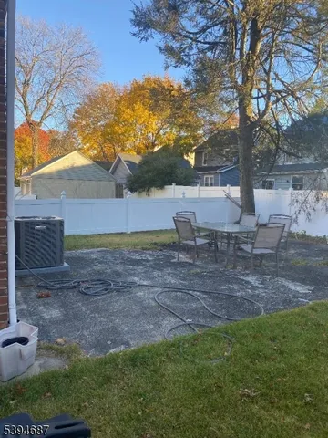 a view of a backyard with large trees