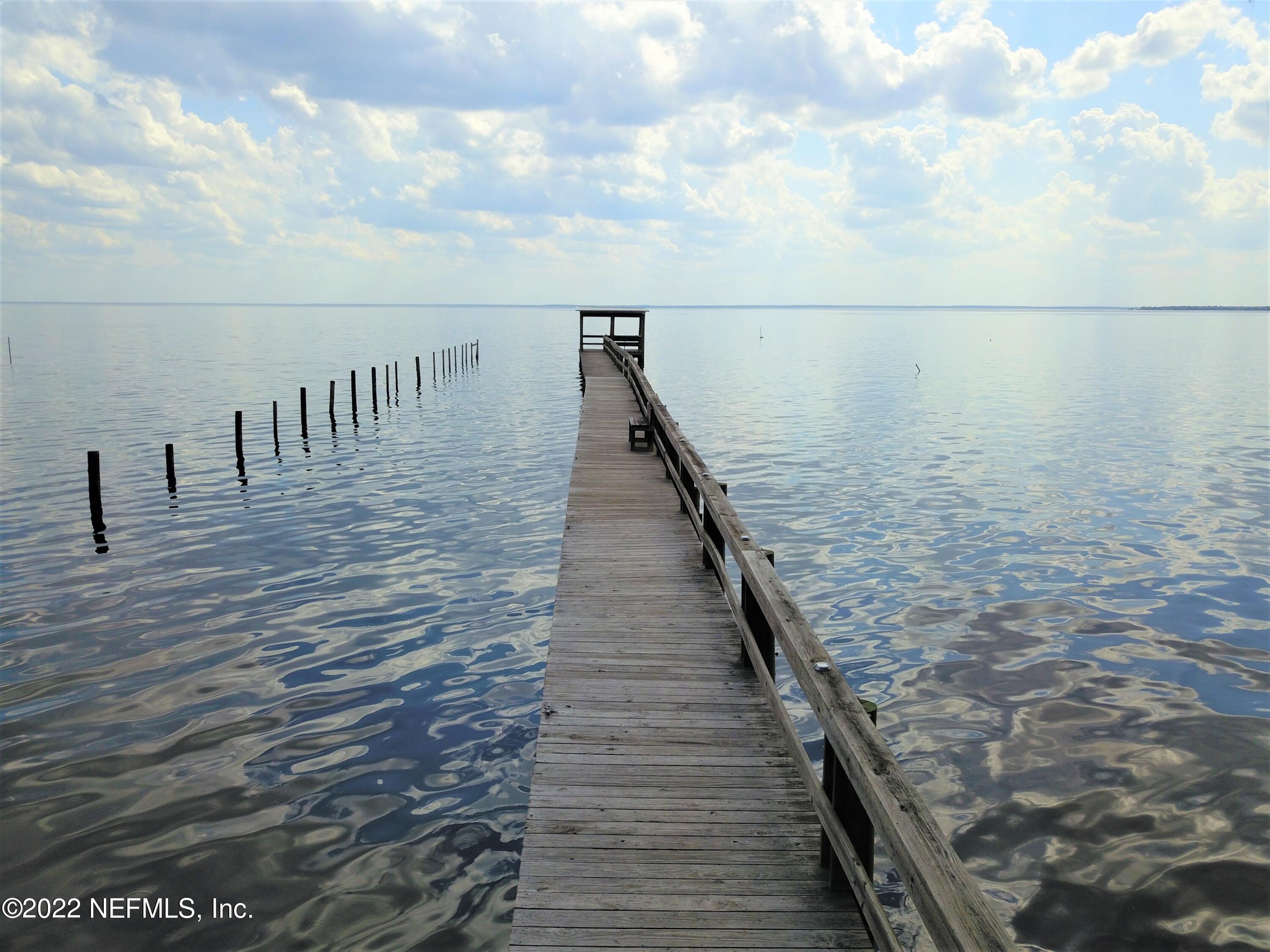 113 3rd Street Georgetown, FL 32139 - Photo 6 of 13 a view of roof deck with wooden floor and fence
