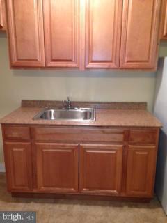 6966 Reisterstown Road Baltimore, MD 21215 - Photo 14 of 17 a close view of washer dryer and cabinets