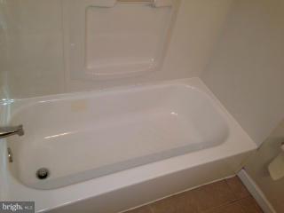 6966 Reisterstown Road Baltimore, MD 21215 - Photo 5 of 17 a view of a bathtub in a bathroom