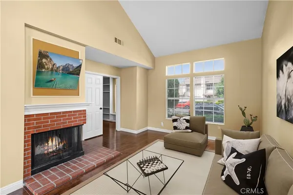 a living room with wooden floors and a fireplace