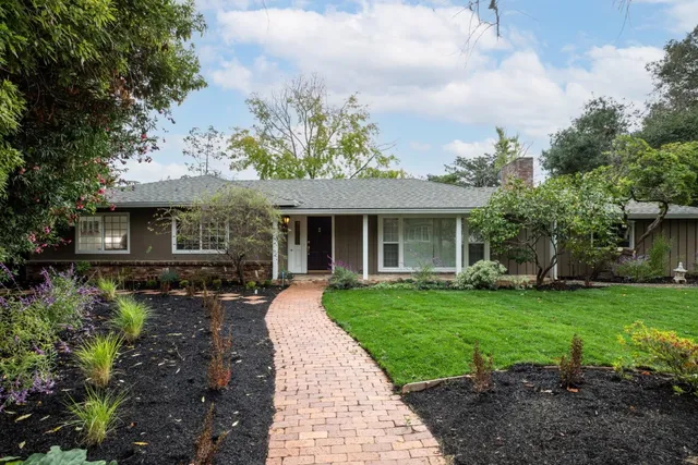 a front view of a house with garden