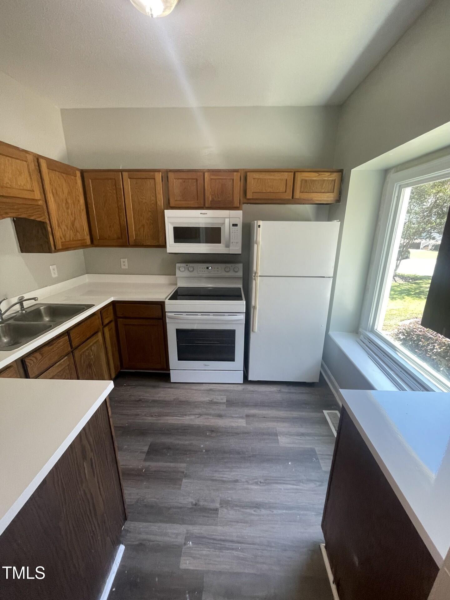 6140 Loch Laural Lane Raleigh, NC 27613 - Photo 11 of 21 a view of kitchen with wooden floor and electronic appliances