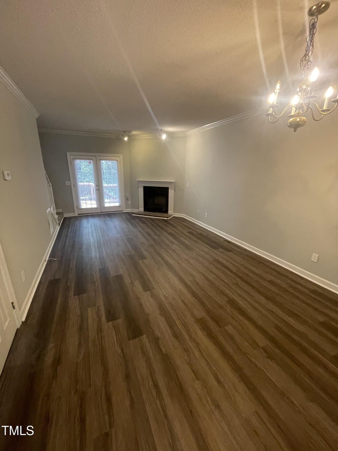6140 Loch Laural Lane Raleigh, NC 27613 - Photo 12 of 21 wooden floor in an empty room with a window