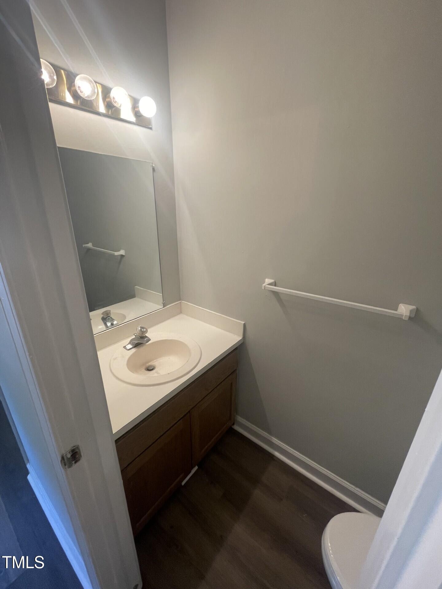 6140 Loch Laural Lane Raleigh, NC 27613 - Photo 13 of 21 a bathroom with a sink toilet and mirror