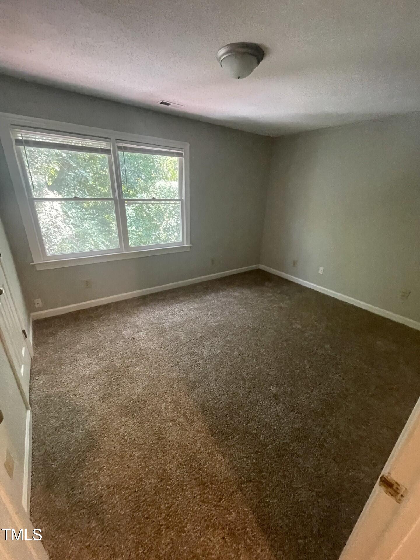 6140 Loch Laural Lane Raleigh, NC 27613 - Photo 19 of 21 an empty room with a window
