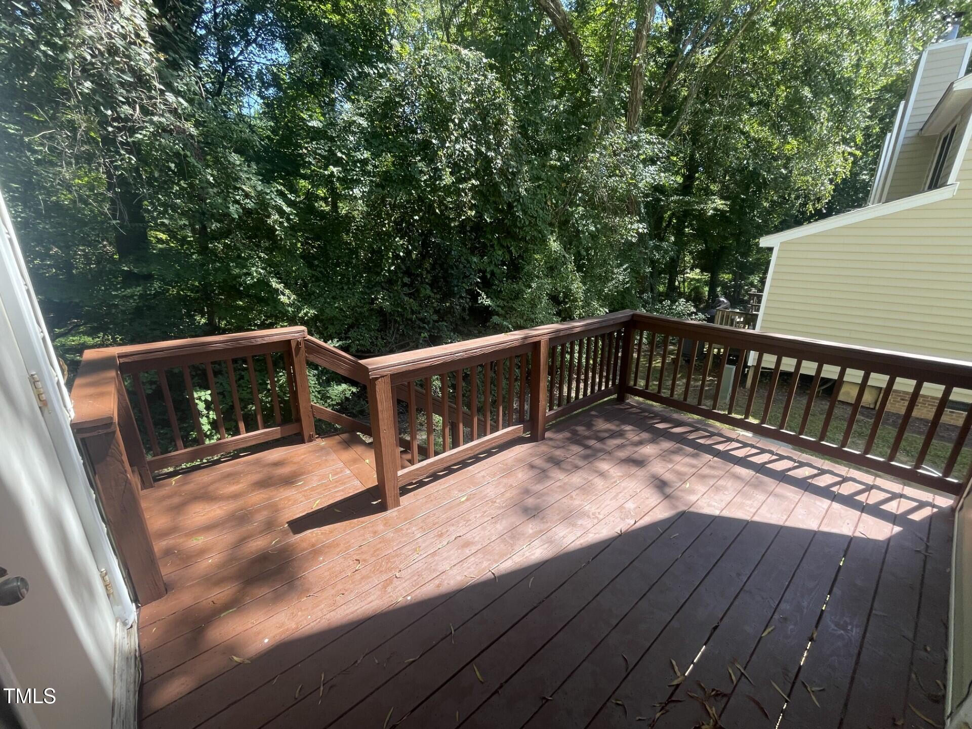 6140 Loch Laural Lane Raleigh, NC 27613 - Photo 5 of 21 a balcony with wooden floor and outdoor seating