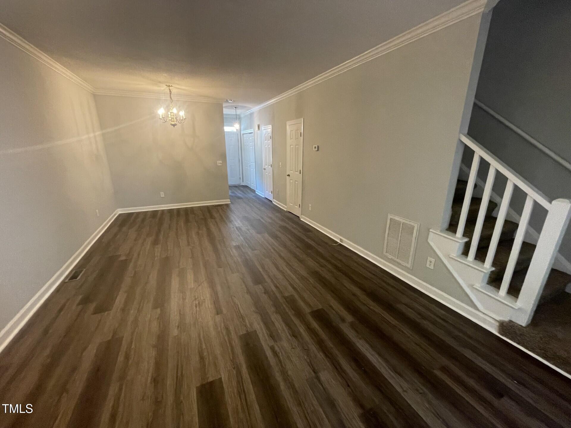 6140 Loch Laural Lane Raleigh, NC 27613 - Photo 8 of 21 a view of an empty room with wooden floor