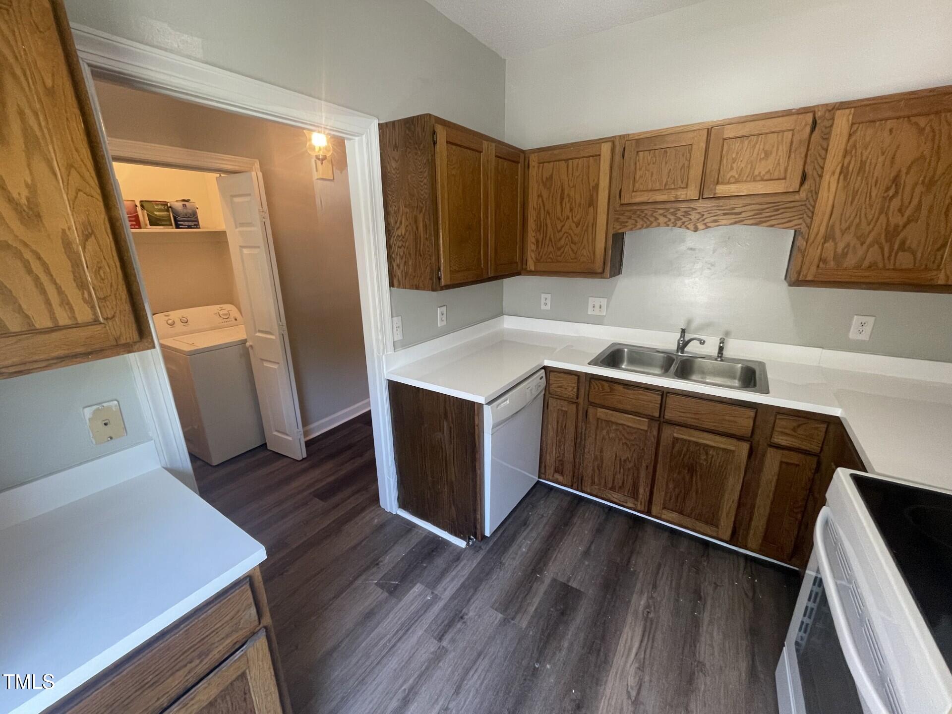 6140 Loch Laural Lane Raleigh, NC 27613 - Photo 10 of 21 a kitchen with sink cabinets and wooden floor