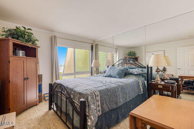 2901 Peninsula Road, Unit 248 Oxnard, CA 93035 - Photo 11 of 26 a bedroom with a bed and a table