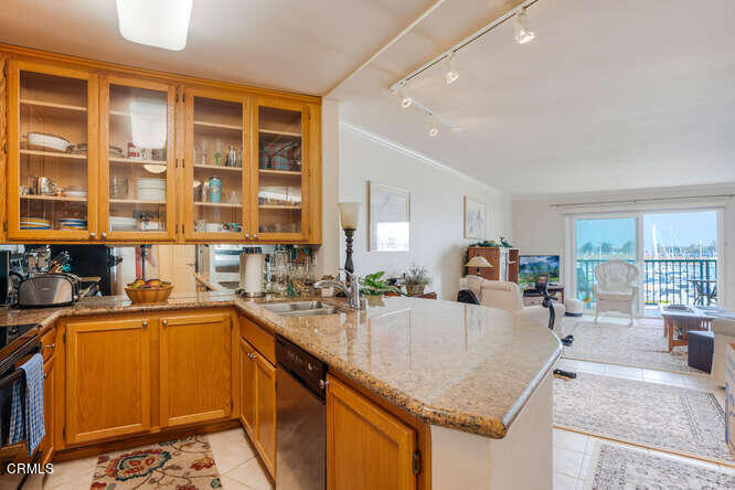 2901 Peninsula Road, Unit 248 Oxnard, CA 93035 - Photo 6 of 26 a kitchen with granite countertop a sink stove and cabinets