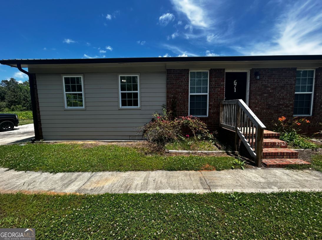 671 Mays Bridge Road Southwest Rome, GA 30165 - Photo 1 of 1 a backyard of a house with a garden