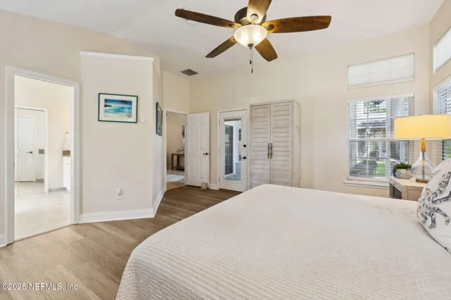 a bathroom with a granite countertop sink a toilet a mirror and shower