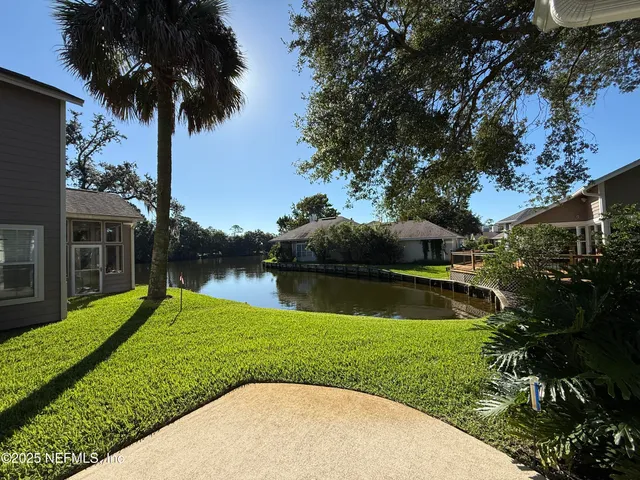 a view of a lake with a house in the background