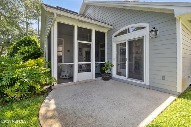 a view of house with garden space and sitting area