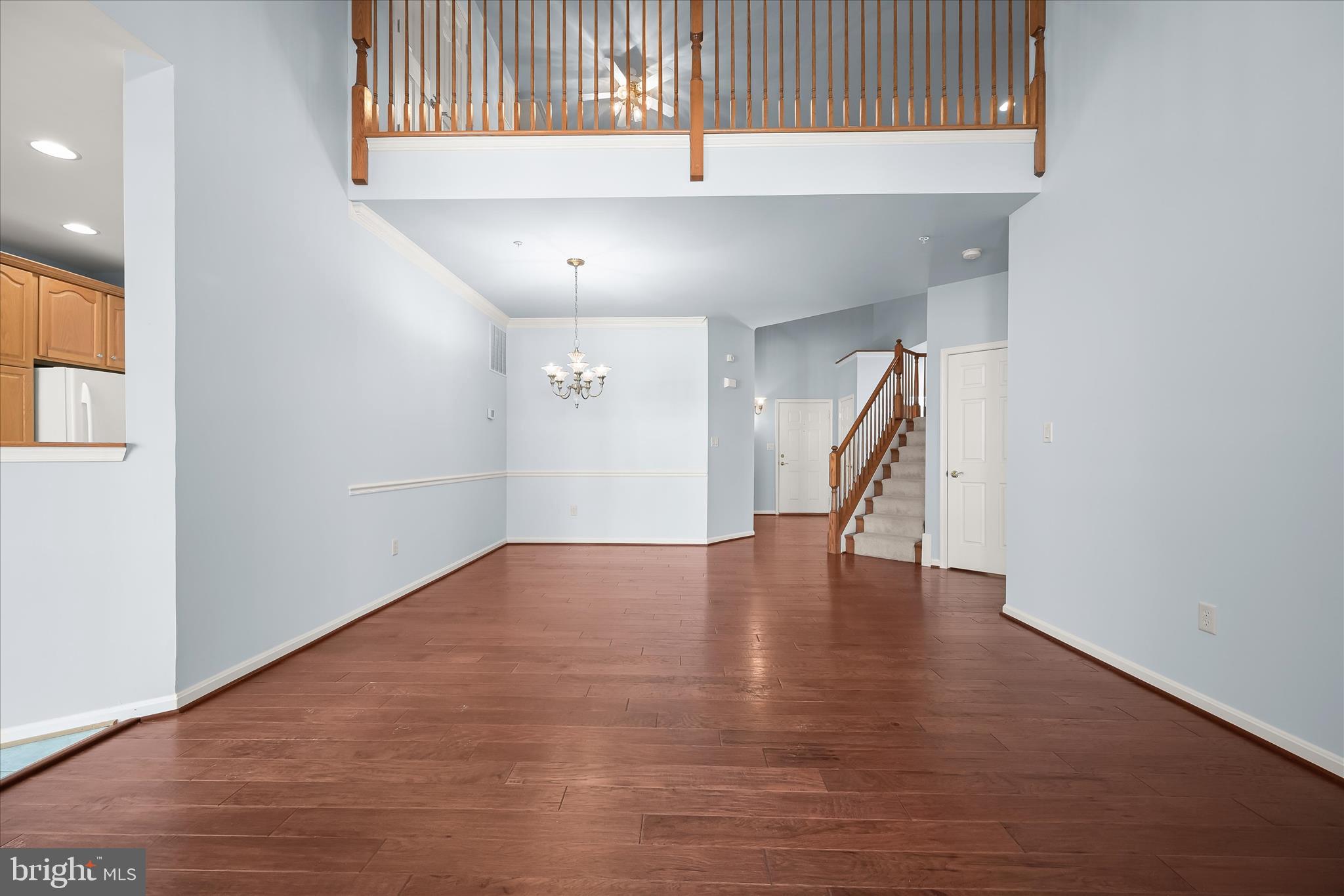 6428 Hickory Overlook, Unit 71 Columbia, MD 21044 - Photo 11 of 63 an empty room with wooden floor and staircase