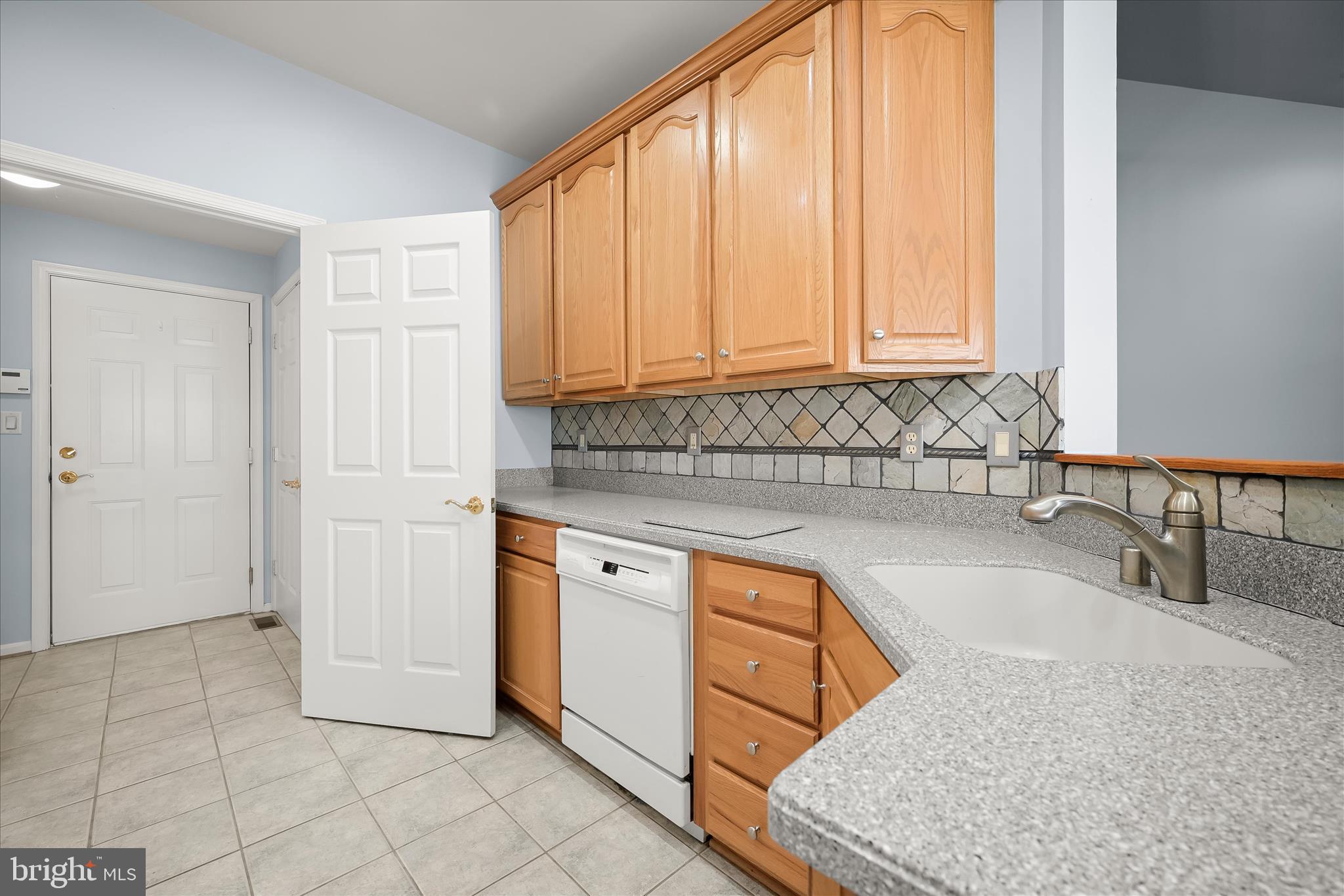 6428 Hickory Overlook, Unit 71 Columbia, MD 21044 - Photo 28 of 63 a kitchen with stainless steel appliances granite countertop a sink and a white cabinets