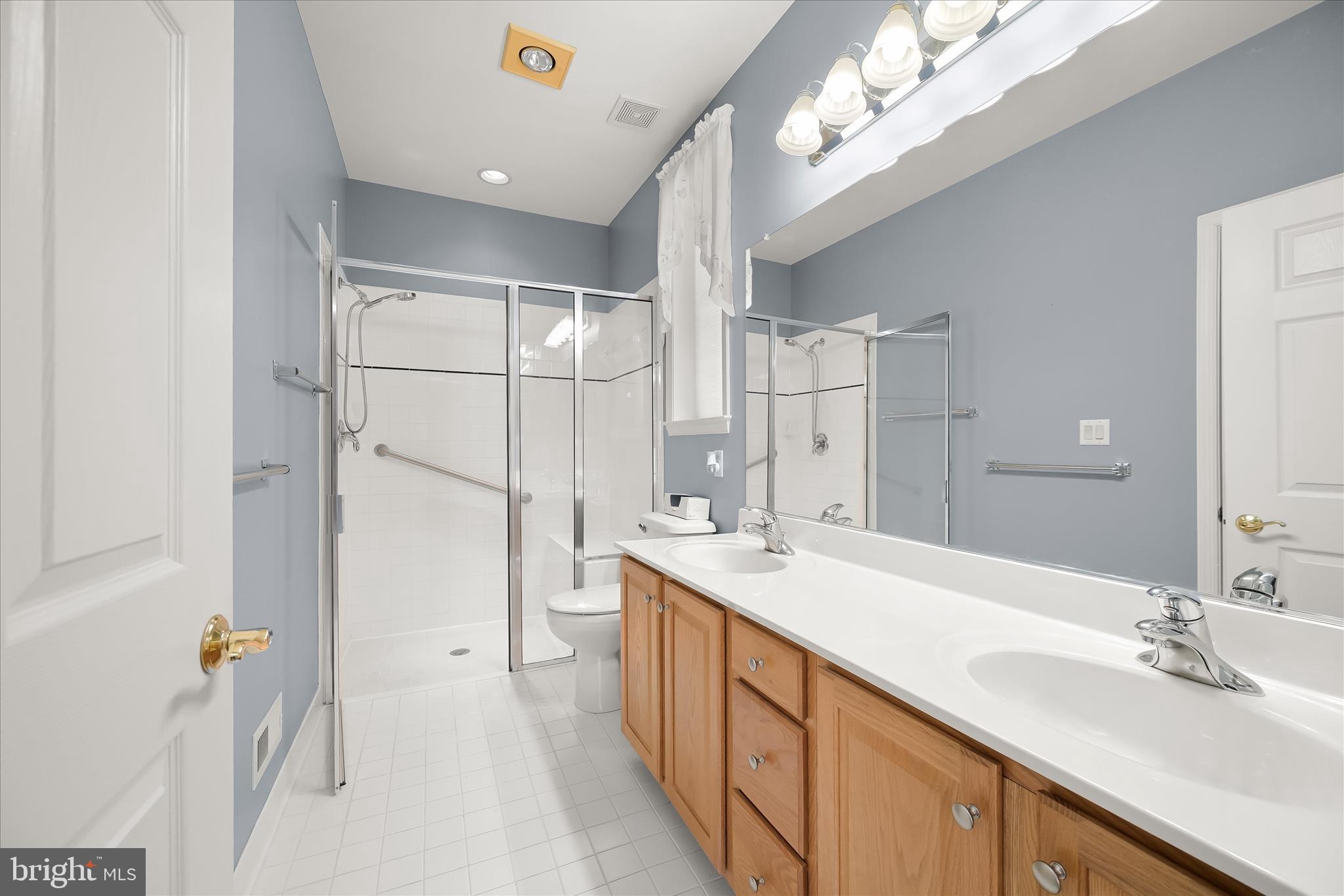 6428 Hickory Overlook, Unit 71 Columbia, MD 21044 - Photo 38 of 63 a spacious bathroom with a double vanity sink mirror and double